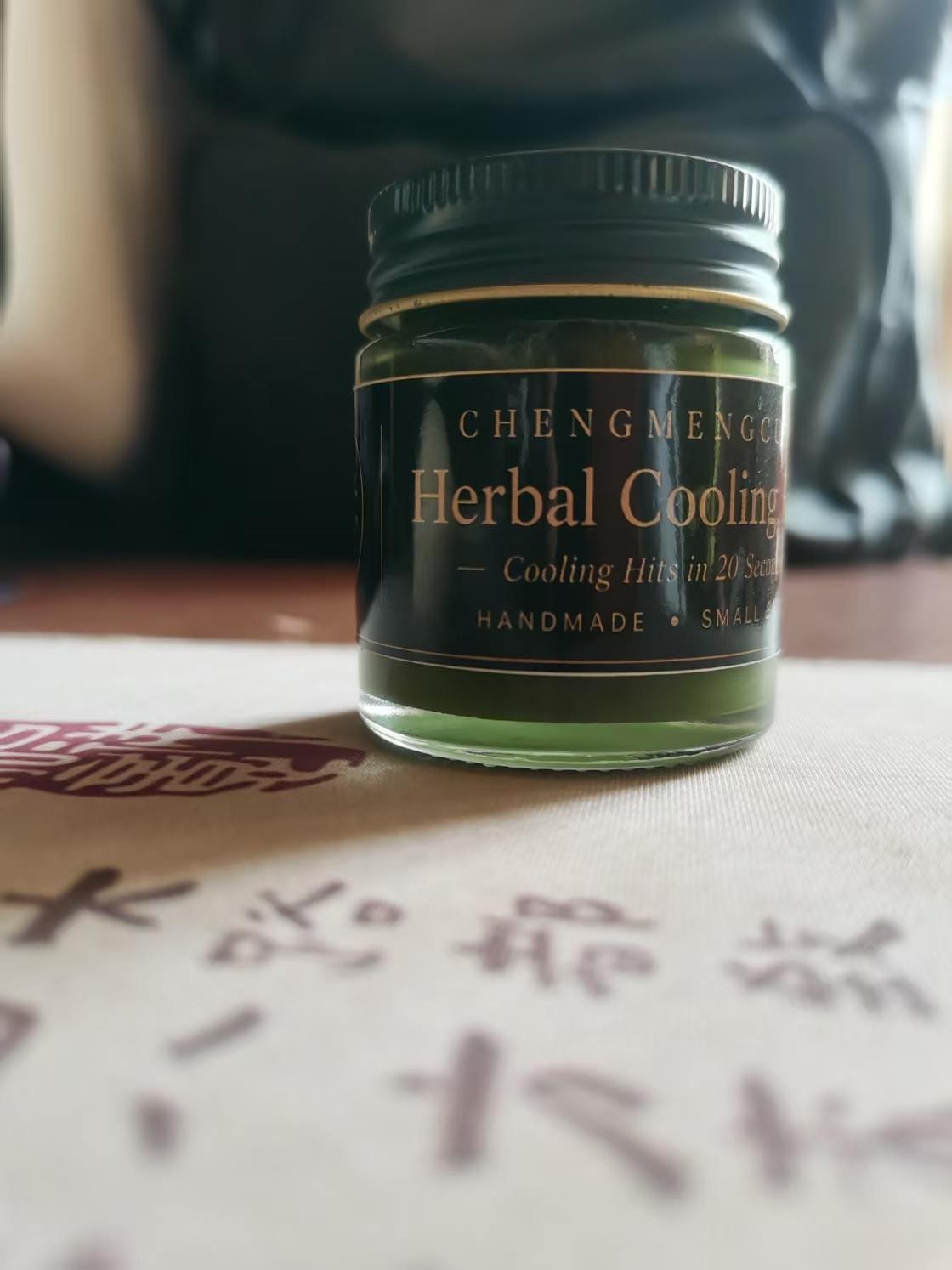 Handcrafted Herbal Cooling Balm in its original green glass jar